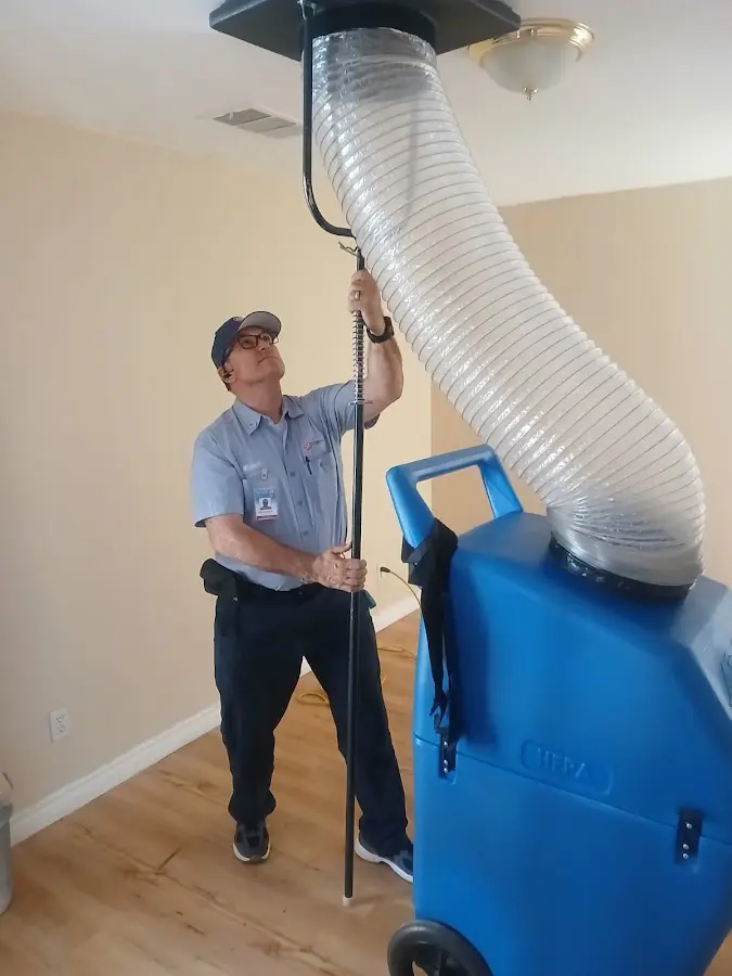 Furnace Tune-Up technician using HEPA equipment in Hernando